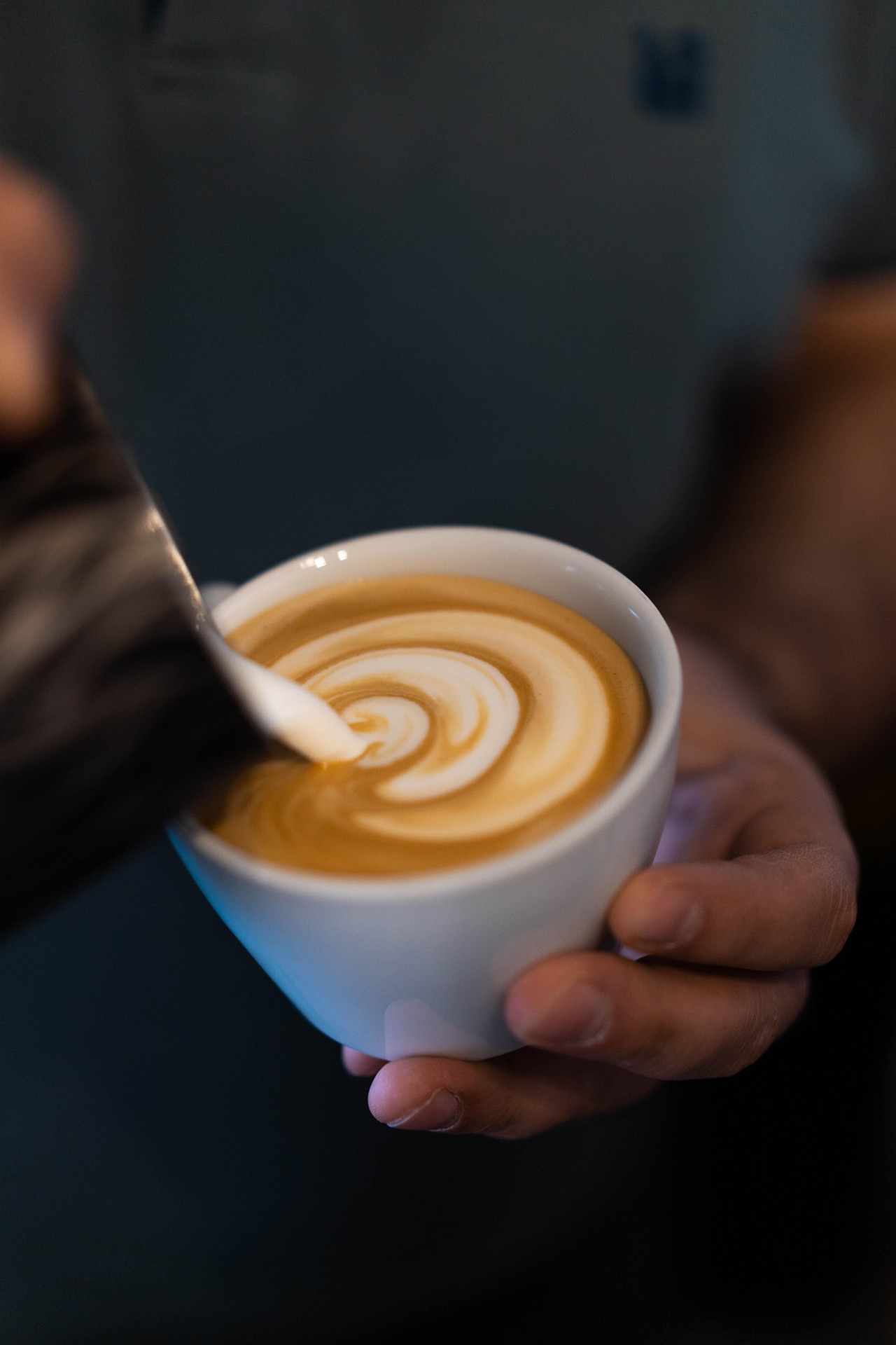 Latte art hälls i en kopp på Café Grindstugan i Tollare